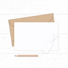 Flat lay top view elegant white composition letter kraft paper envelope pencil and tag on wooden background