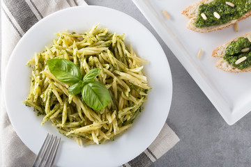 Traditional trofie pasta with pesto sauce on white plate