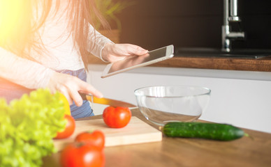 Obraz na płótnie Canvas Young trendy woman cooking healthy food in the morning