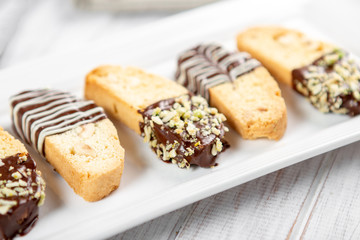 Fototapeta na wymiar Cantuccini biscuits with chocolate and pistachios. Italian biscotti on white plate