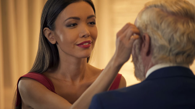 Sexy young lady flirting with old business man, stroking face, escort  service Stock Photo | Adobe Stock