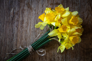 Bouquet of yellow narcissus on wooden table