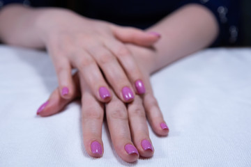 Fototapeta premium Hands with beautiful nails painted bright, manicure