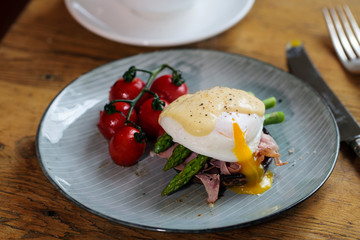 Fototapeta na wymiar Breakfast with mushroom, poached egg, asparagus and tomatoes