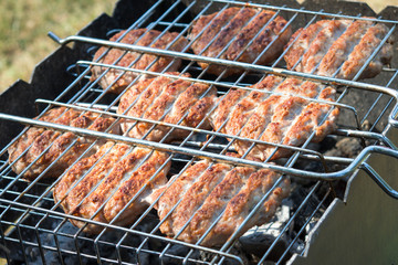 Beef or pork meat barbecue burgers for hamburger prepared grilled on bbq  grill, high angle view, close up