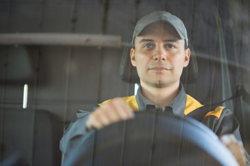 Smiling van or truck driver on the road