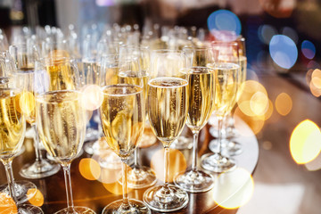Champagne glasses on sparkling background.