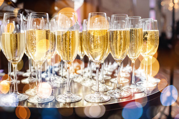 Champagne glasses on sparkling background.