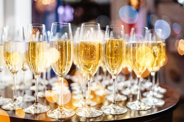 Champagne glasses on sparkling background.
