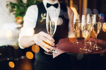 Champagne glasses on sparkling background.