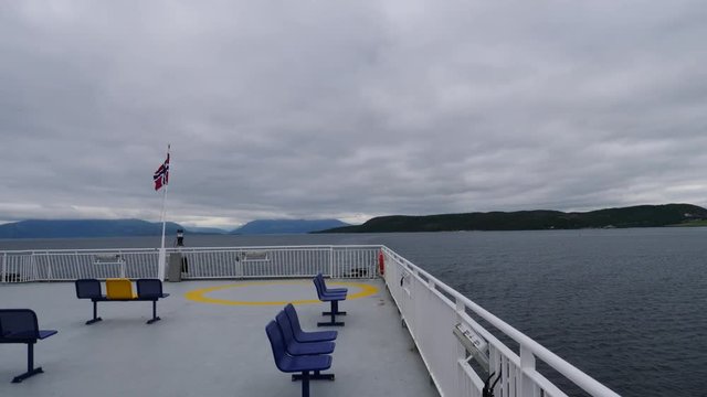 Ferry deck with empty seats and sea view in the background. Ferryboat ride route Bognes - Lodingen to Lofoten islands Norway. Tourism vacation and travel