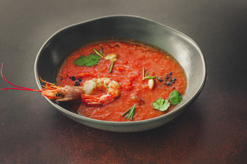 Gazpacho soup with prawns shrimps (tomato red soup with seafood) portion. food background. copy space