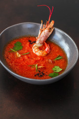 Gazpacho soup with prawns shrimps (tomato red soup with seafood) portion. food background. copy space