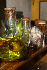 jars of oil and vinegar in bookshelf