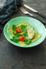 zucchini grilled with tomato and cream cheese, sauce, garlic and microgreen (warm salad snack). food background. copy space