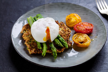 Courgette rosti, poached egg, asparagus and roast tomatoes