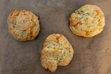 Three cheese scones on greece-proof paper