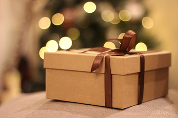close-up open and closed gift box with brown ribbon