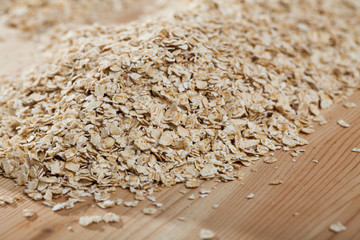 Oatmeal flakes on wooden surface