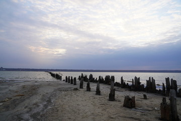 Kuyalnik estuary landscape. Kuyalnik liman salt lake in Odessa region of Ukraine. Wooden piles in a salt lake Kuyalnik estuary