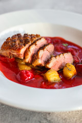duck breast roasting, vegetables, berry sauce and microgreen (main dish). food background. top view