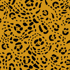 Seamless animal print, black spots on an orange background. Stock vector illustration.