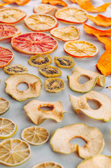 Mixed dried fruits and vegetables slices on white background