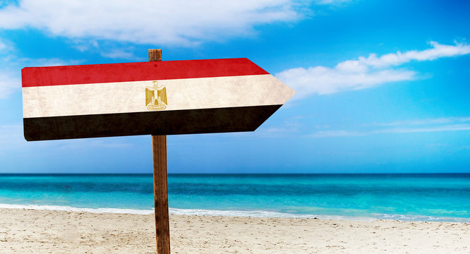Egypt flag on wooden table sign on beach background. It is summer sign of Egypt.