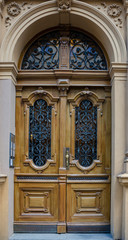 Wooden door with ornaments of wrought iron