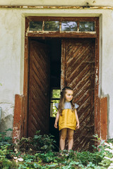 beautiful girl in a yellow dress near a wooden door
