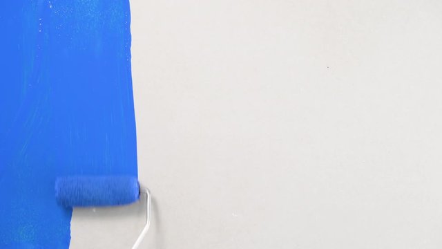 Painting of walls in a  blue color for repair old paint in a house