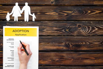 Family and adoption child concept with application on wooden background top view mockup