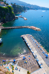 Fototapeta premium Seascape beautiful famous coastline. Aerial view of small beach. Sant'Agnello near Sorrento, Naples, Campania, Italy.