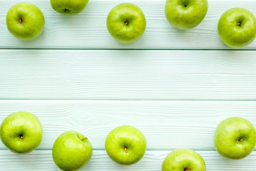 food pattern with green apples on light wooden background top view space for text