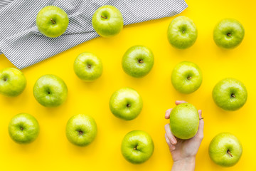 green apples for organic summer food pattern on yellow background top view