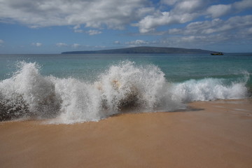 waves crashing on the beach in maui