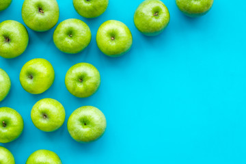 summer fruit pattern with apples on blue colorful background top view copyspace