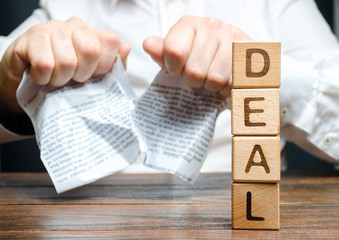 Word deal and businessman is breaking a contract in the background. Contract break unilaterally....