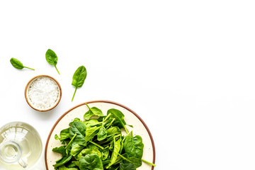 organic food pattern with green salads mix and oil white background top view space for text