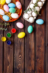 Colorful eggs for easter on wooden background top view mockup