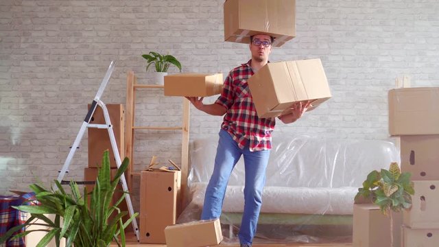 Man in glasses and shirt with boxes on his head, hands and feet