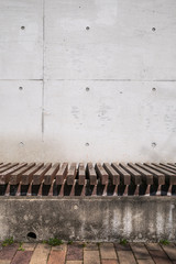 A bench in front of a concrete wall