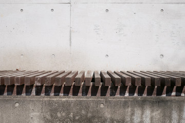 A bench in front of a concrete wall