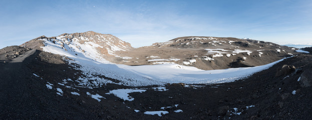 Panoramic view across the crater at the top of Kilimanjaro taken from close to Stella Point. A path...