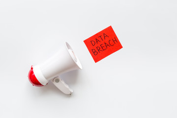 Data breach concept with megaphone on white background top view