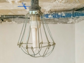 Bulb in a work with metal protection that surrounds it and the bottom of the construction