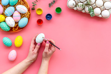 paint eggs for Easter celebration on pink background top view mock up