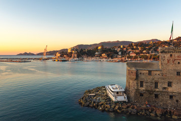 Broken yacht near ruins of old fortress in Rapallo town,Liguria, Italy
