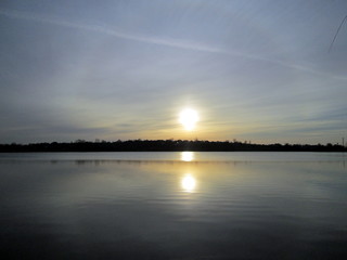 Sunrise. Dawn over the lake. Surreal Sun. 