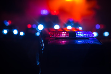 Police cars at night. Police car chasing a car at night with fog background. 911 Emergency response...